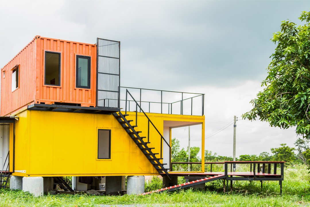 Une maison bicolore mise en valeur pas des escaliers en métal.